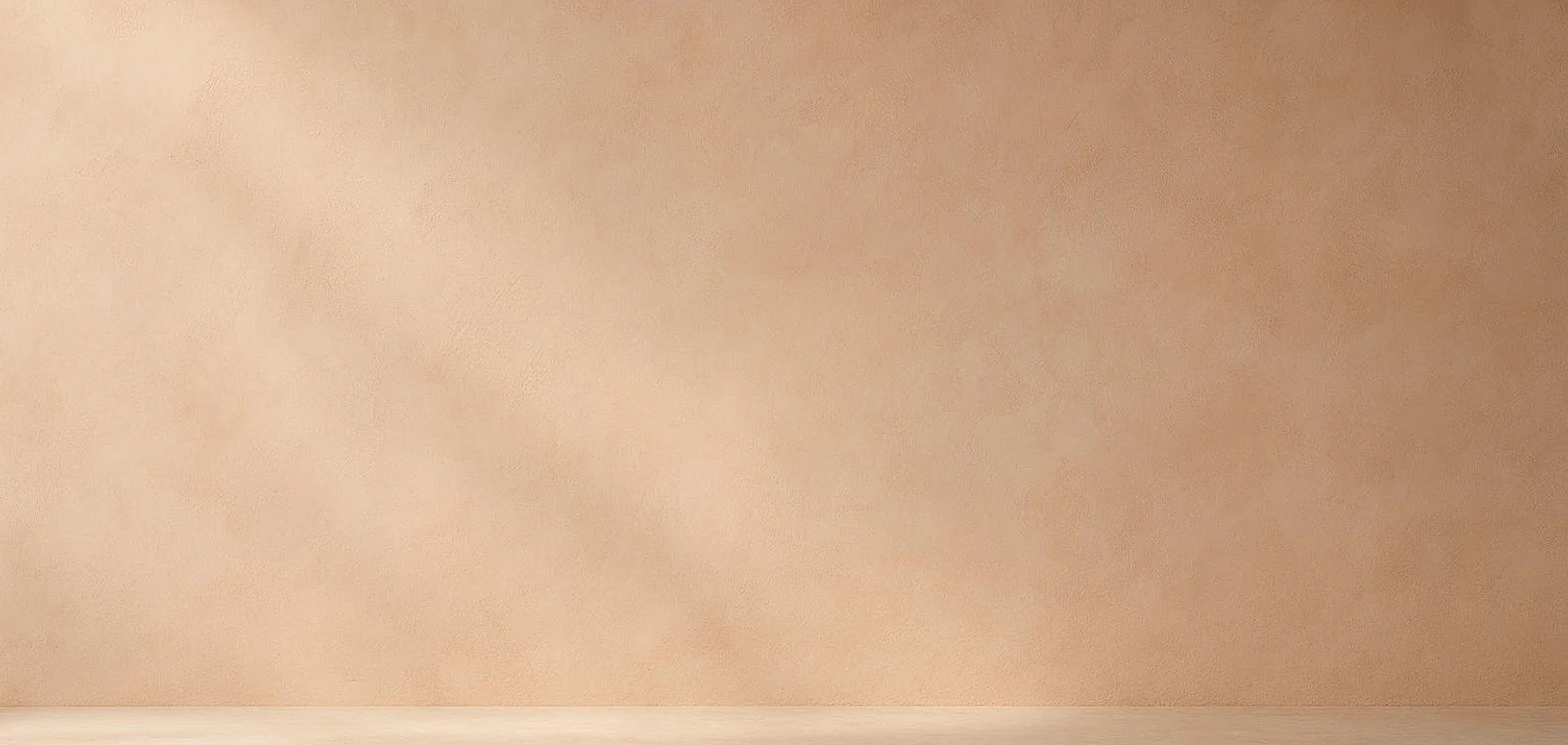 Warm blush-beige plaster wall with stone ledge